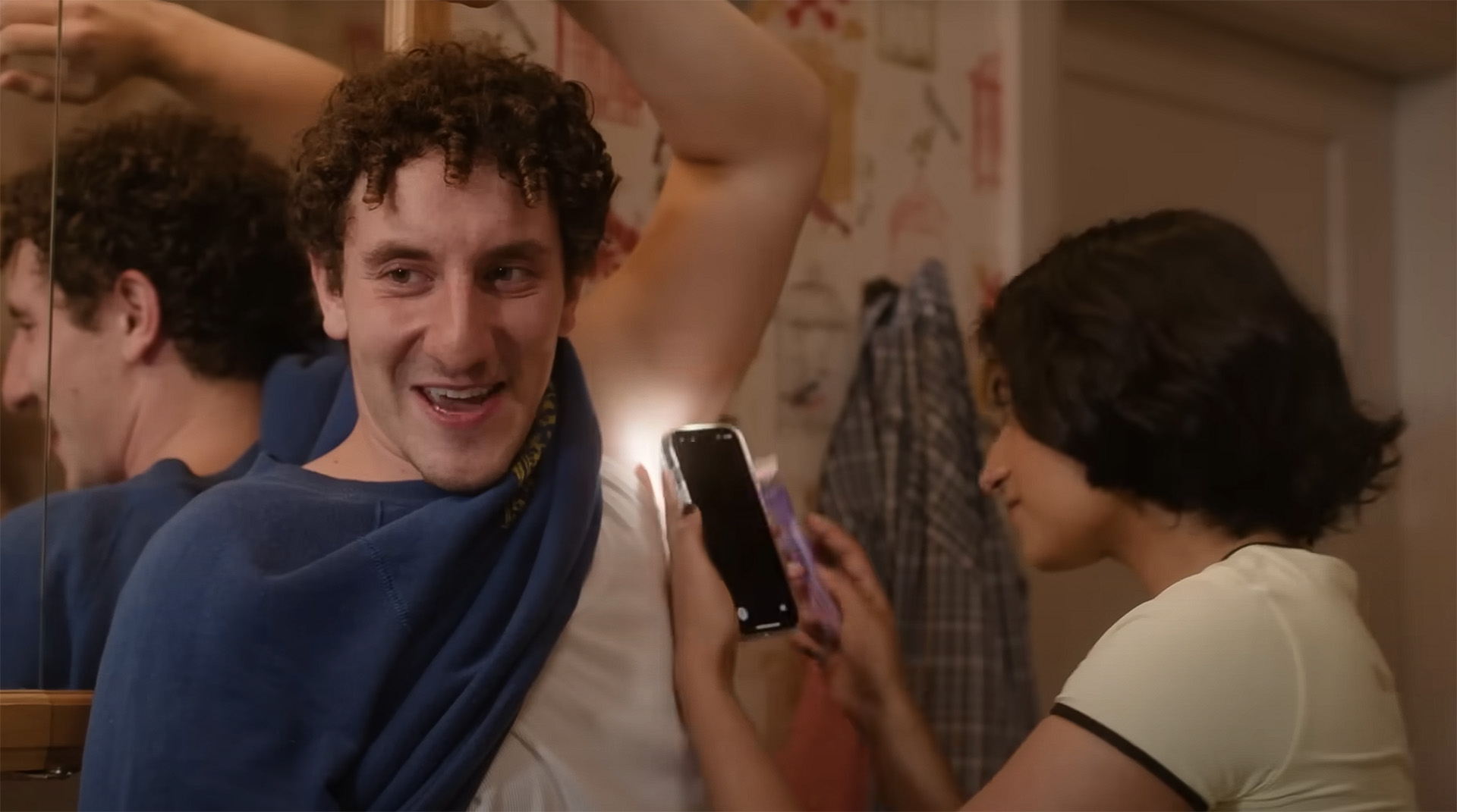 Two characters of Adults. One is looking at someones arm.