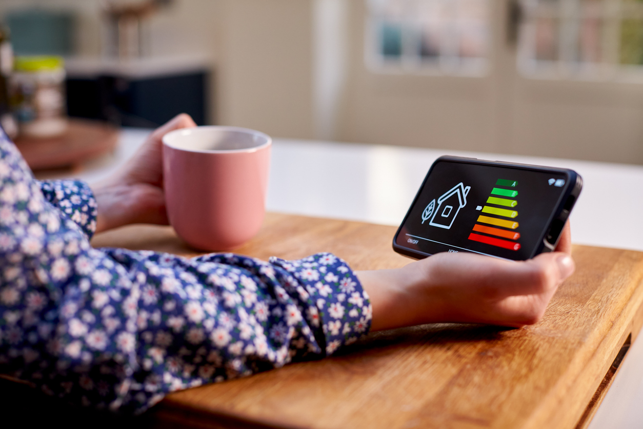 Close up van iemand die een tablet vasthoudt met daarop energiedata